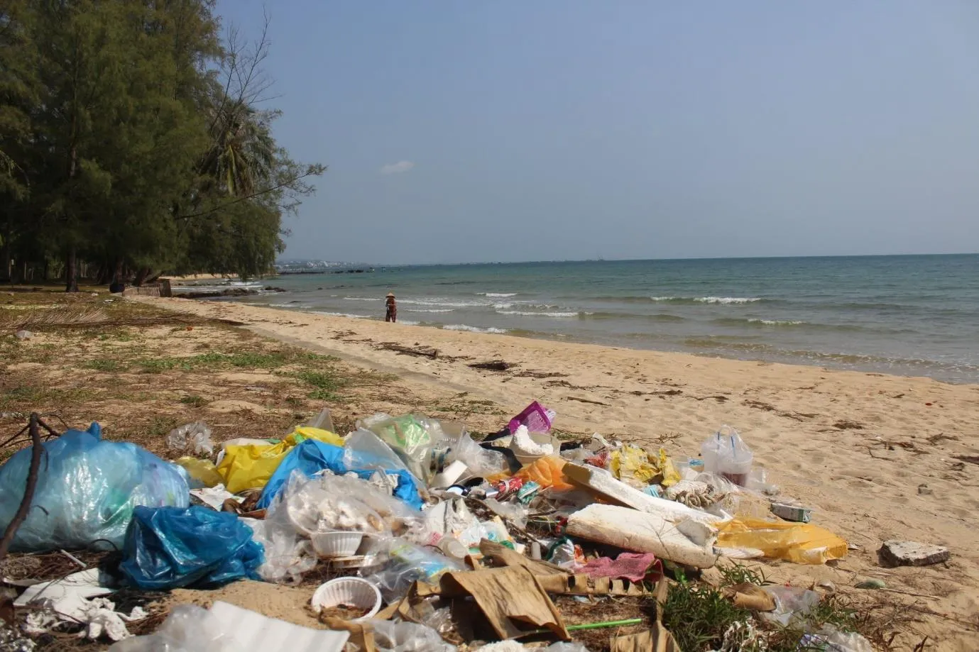 Một phụ nữ đứng trên bãi Ông Lang đầy rác thải trên đảo Phú Quốc. Ảnh: Sen Nguyễn